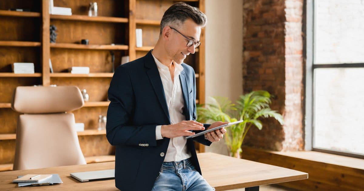 High-earning professional reviewing private market investment strategy on tablet in modern office