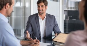 financial advisor showing investment graph to couple