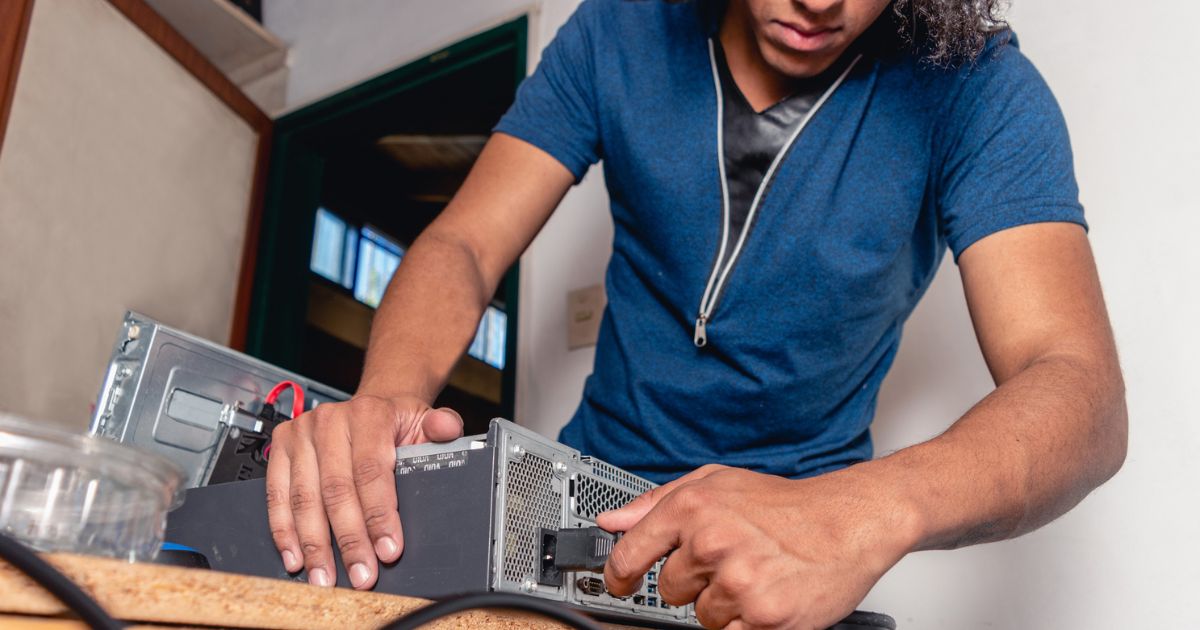 Teen installing new computers in parent's business