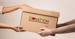 Hands holding a donation box symbolizing charitable giving and donor-advised fund