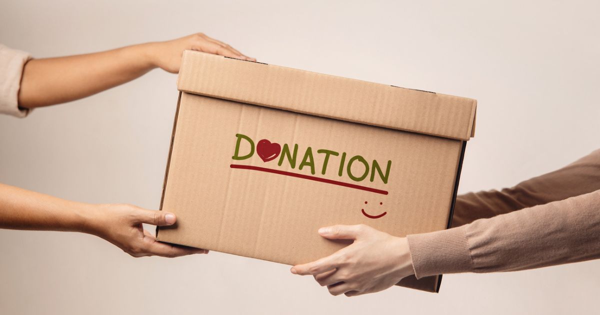 Hands holding a donation box symbolizing charitable giving and donor-advised fund