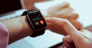 Person checking health data on smartwatch